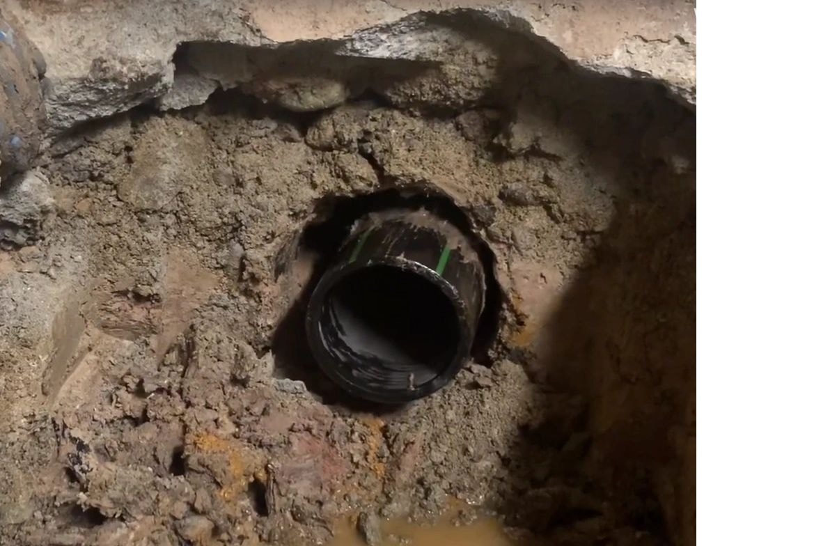 Pipe bursting equipment and crew completing underground pipe replacement